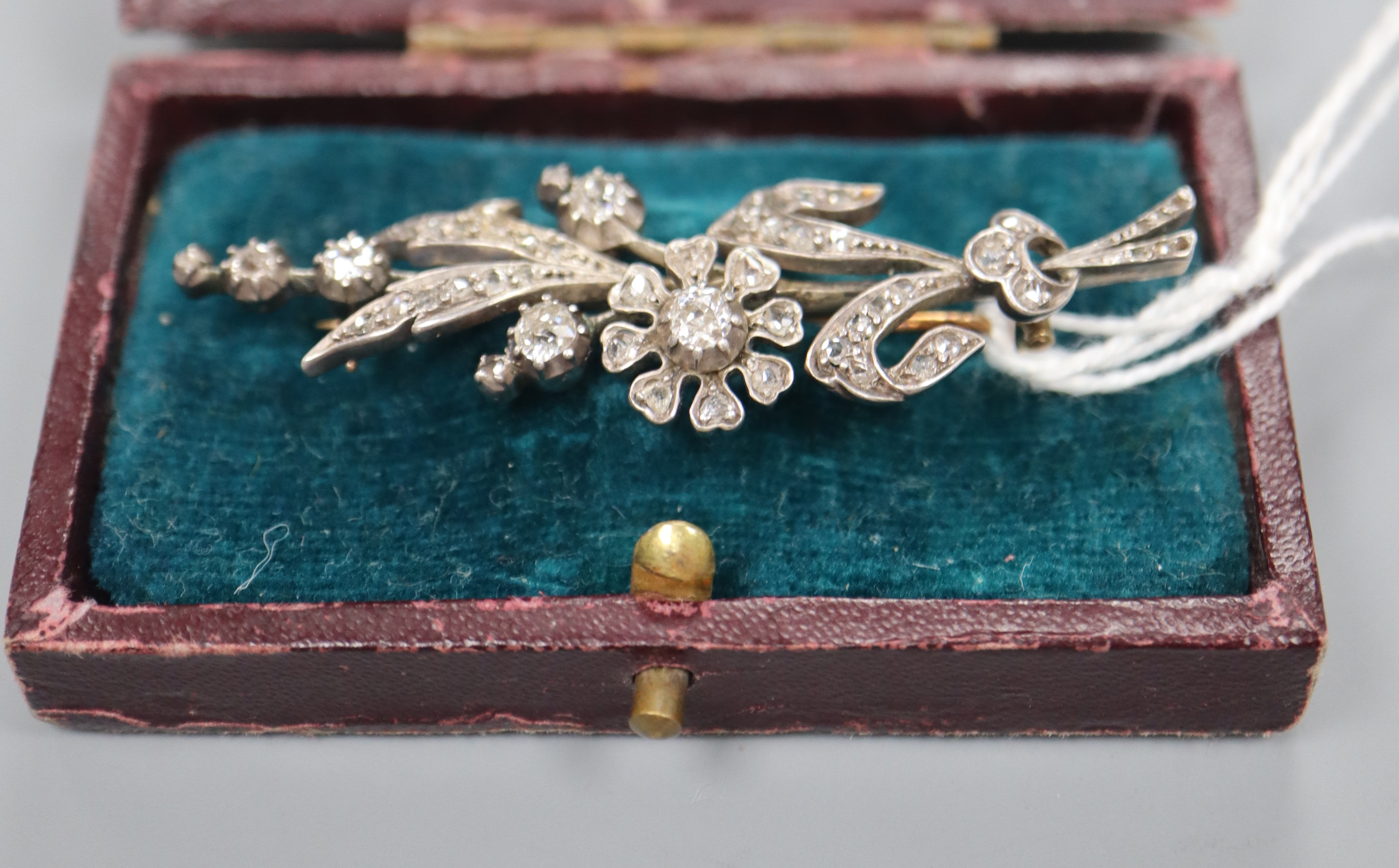 A Victorian yellow and white metal, diamond set floral spray brooch, 58mm, gross 7.5 grams.